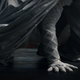 The white-robed hand of Marvel's Moon Knight steadies the superhero as he crouches in a three-point landing pose, in footage from Marvel Studios' Disney+ series.
